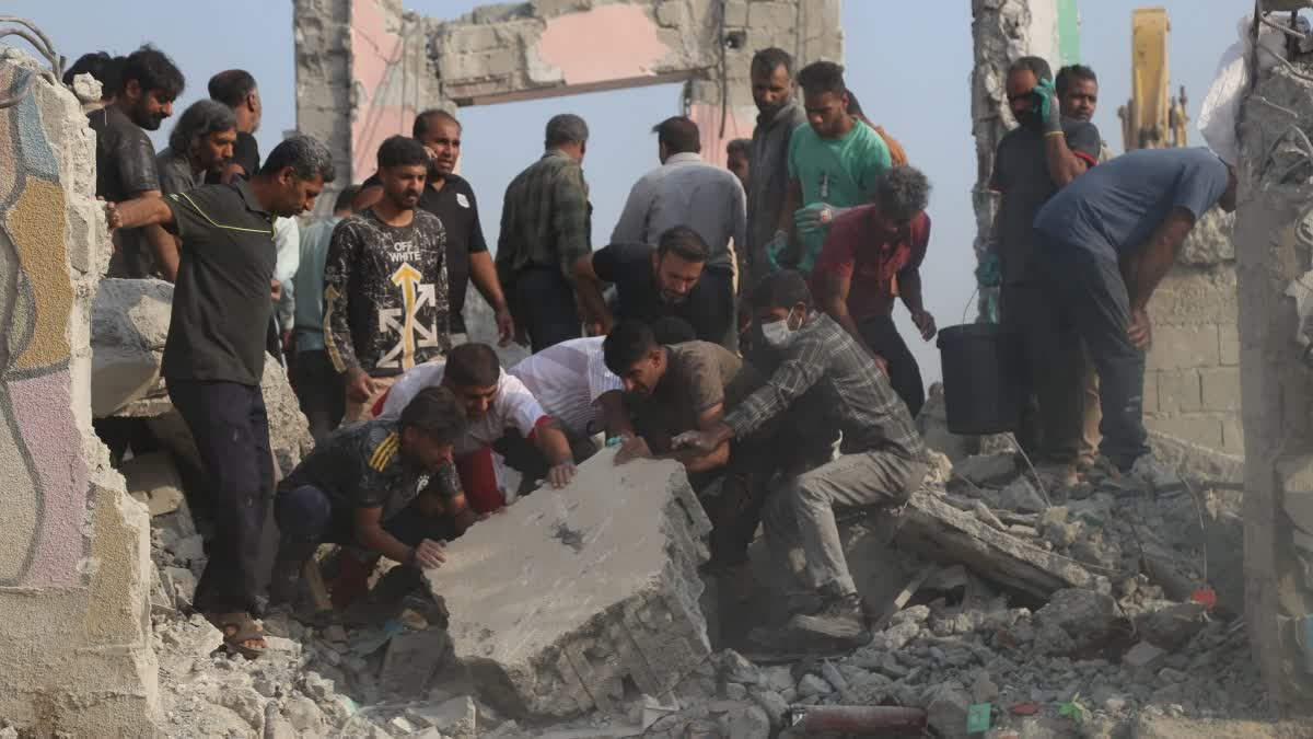 Rescue workers and residents search through the rubble in the aftermath of what Iranian officials said was an Israeli-U.S. strike on a girls' elementary school in Minab, Iran, Saturday, Feb. 28, 2026