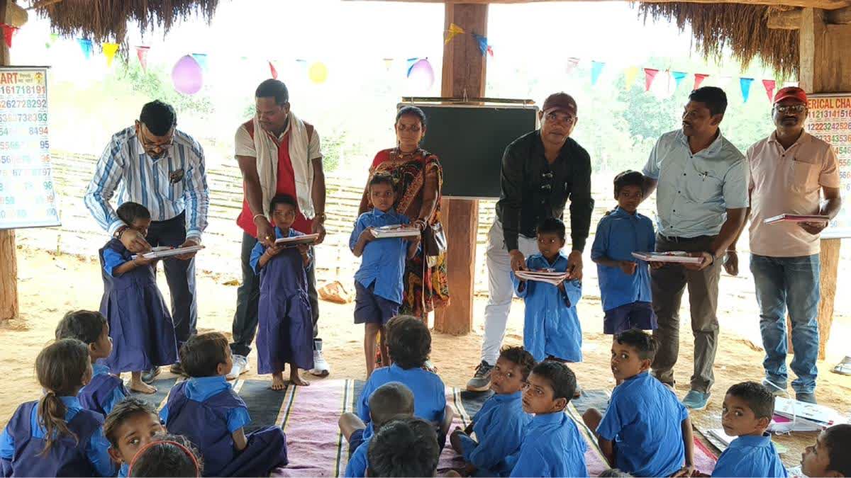 Children being distributed free books in the newly-opened school.