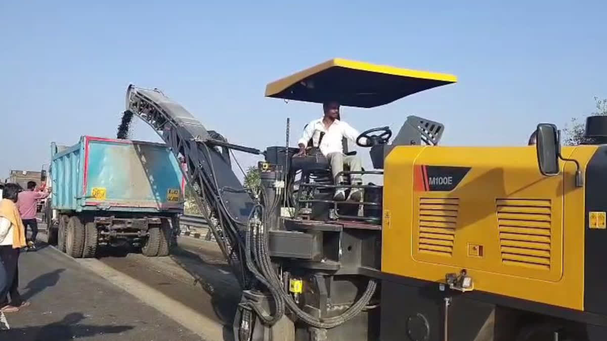 Machine removing the top layer of the expressway road