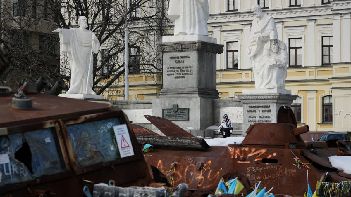 A child plays next to an open air exhibition of destroyed Russian military equipment in Kyiv, Ukraine, Saturday, Feb. 28, 2026