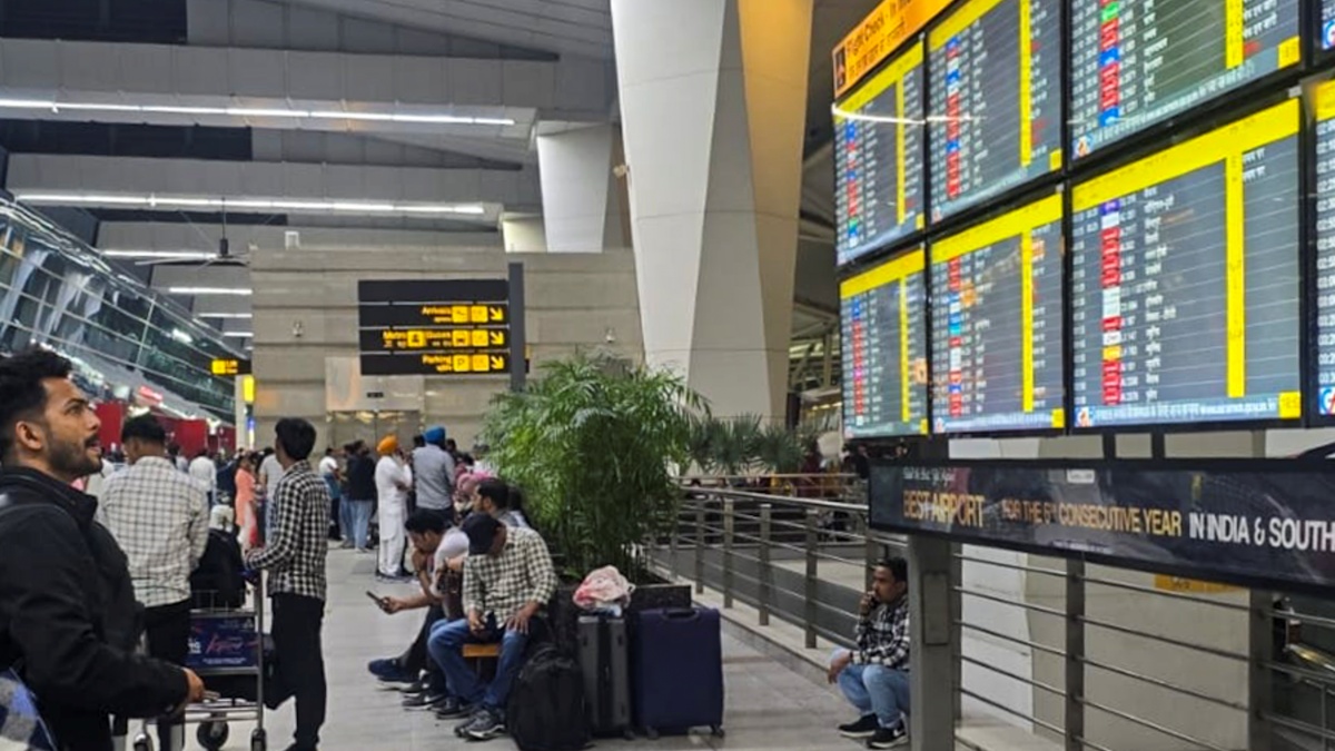A passenger looks at a display showing flight schedule, amid cancellation of flights to the Middle East due to the US and Israel strikes on Iran, at the Indira Gandhi International (IGI) Airport, in New Delhi, Saturday, Feb. 28, 2026.
