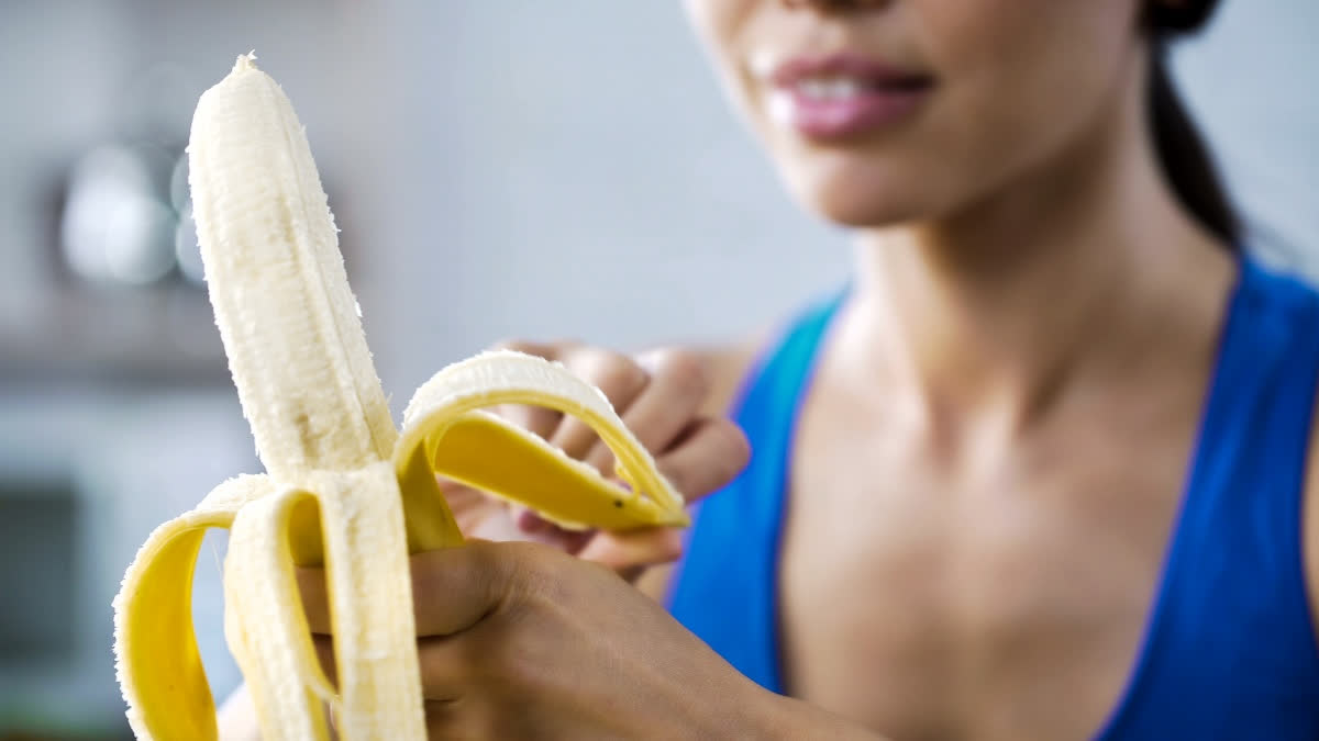 Fit woman eating a banana