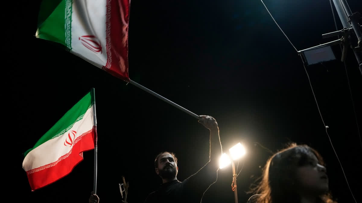 Demonstrators wave Iranian flags during a pro-government gathering at Islamic Revolution Square in Tehran, Iran, Saturday, May 30, 2026.