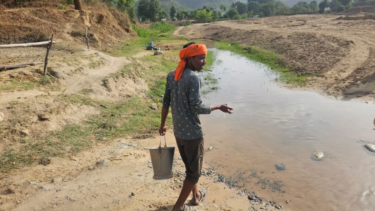 A Khairahi villager goes to fetch water