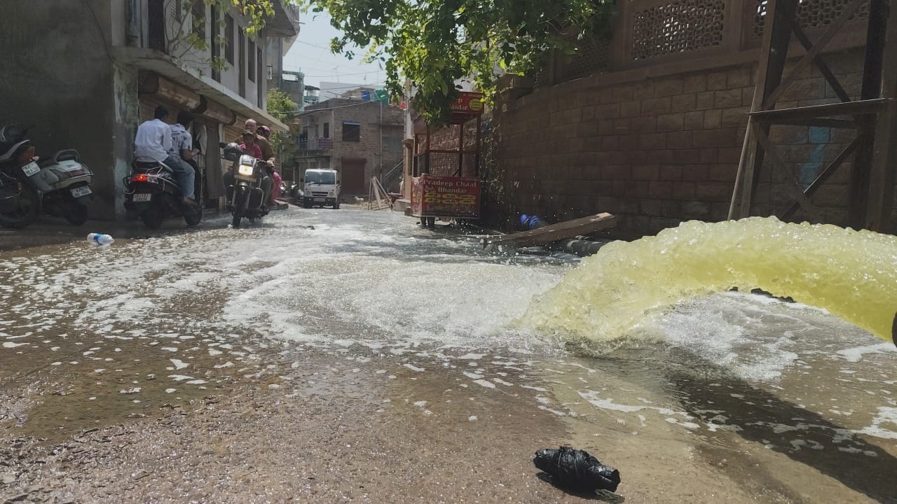 पानी सड़क पर बहता हुआ आगे नाले में जा रहा है