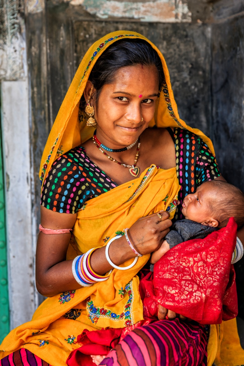 Woman in a village breastfeeding her baby