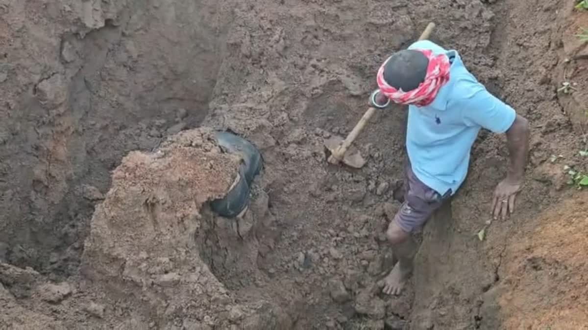 living laborer buried under soil