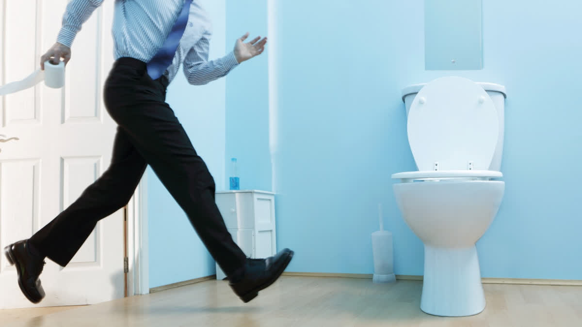 Man rushing to the toilet