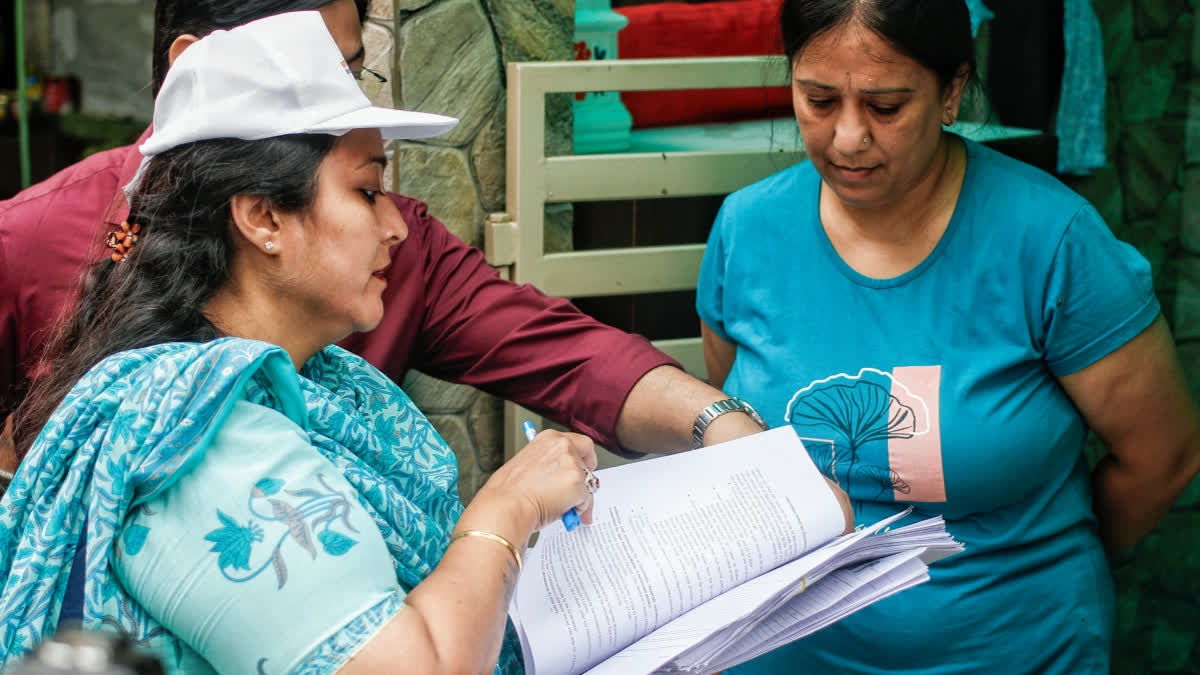 A Booth Level Officer (BLO) conducts the Special Intensive Revision (SIR) door-to-door voter verification drive at BK Dutt Colony, Jor Bagh, in New Delhi.