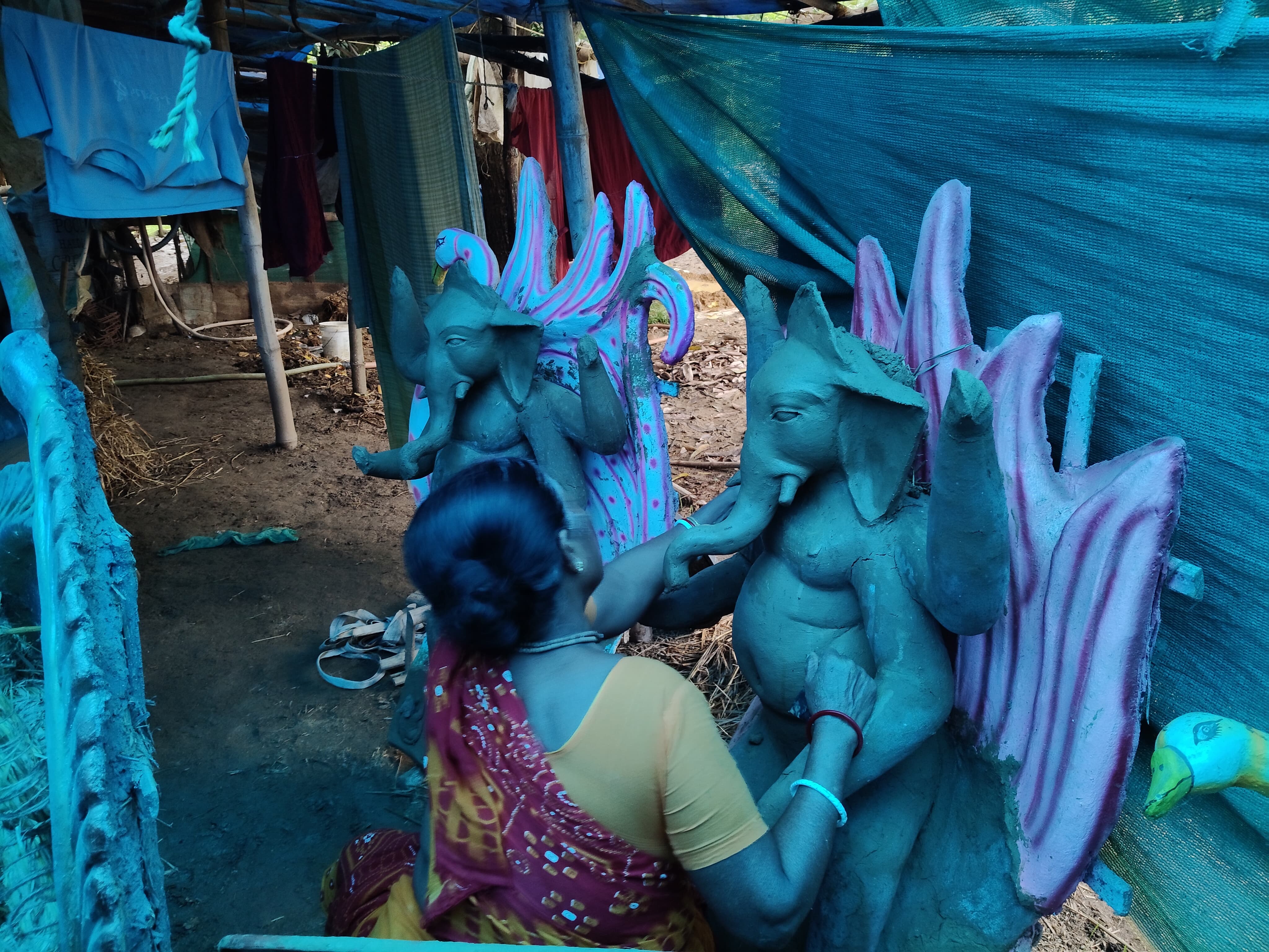 Bengali sculptors shaping Ganesha