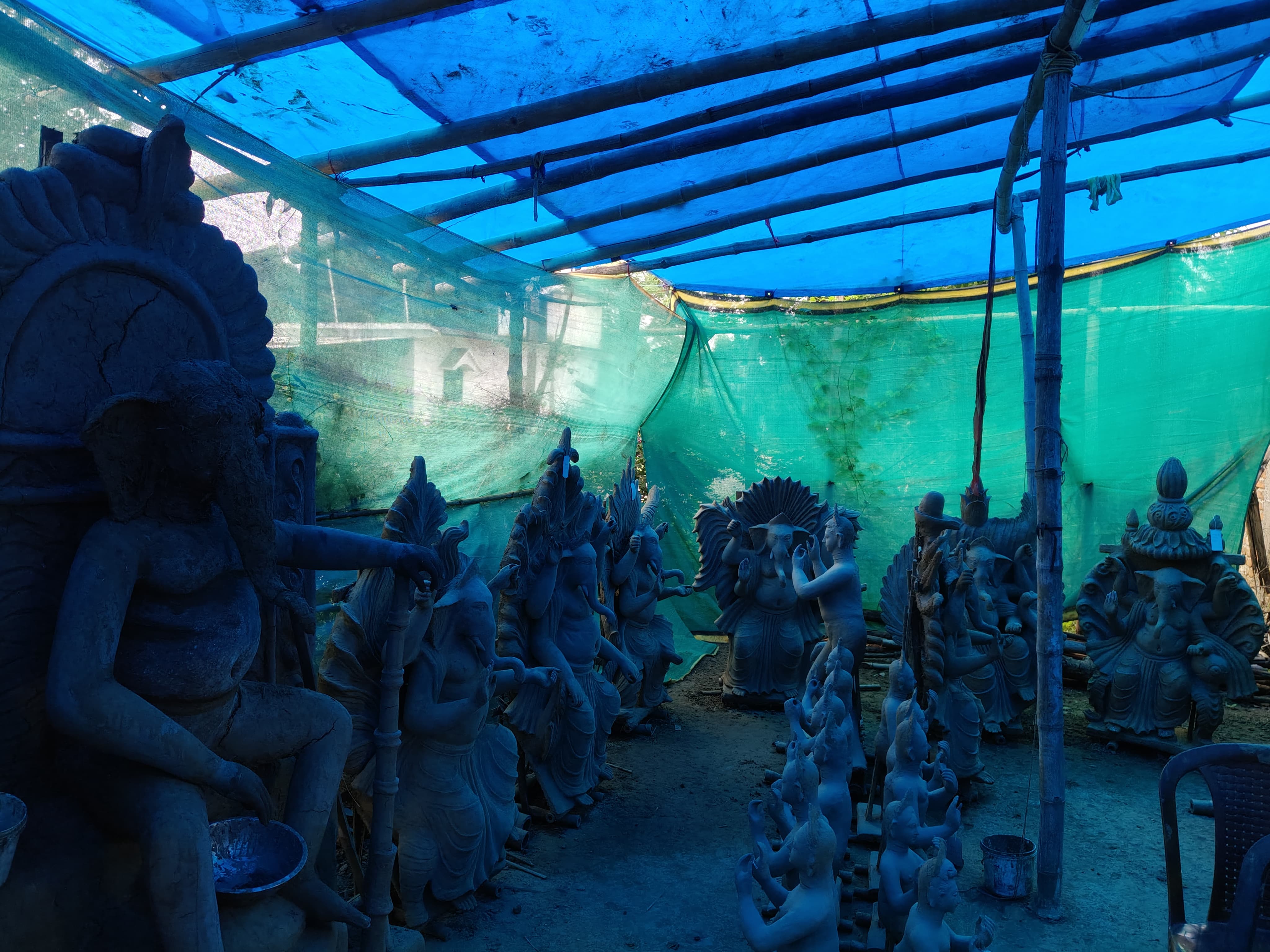 Bengali sculptors shaping Ganesha