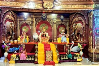 girls sitting as Durga in pandal
