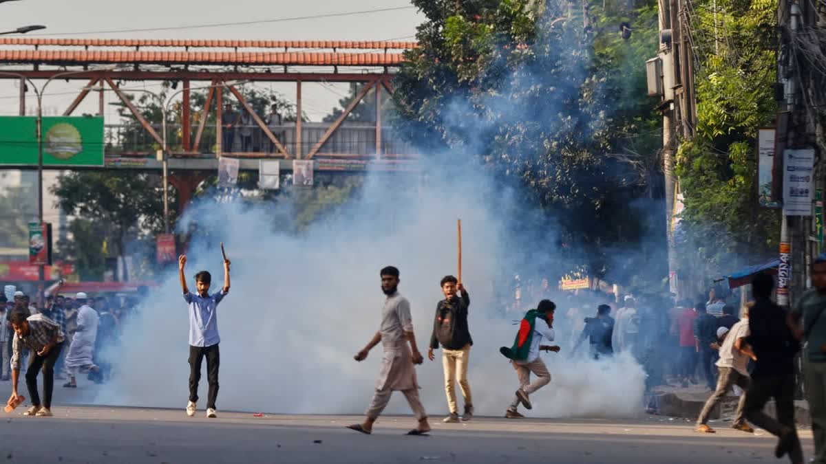 Protesters throw stones and shout slogans during a standoff with police outside the demolished residence of Sheikh Mujibur Rahman, Bangladesh's former leader and the father of the country's ousted Prime Minister Sheikh Hasina after the verdict against Hasina, in Dhaka, Bangladesh, Monday, Nov. 17, 2025
