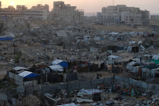 Makeshift tents for displaced Palestinians stand among the ruins left by Israeli airstrikes in the Al-Karama neighborhood of Gaza City on Sunday, Nov. 30, 2025.