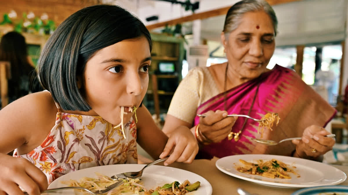 Grandmother and granddaughter eating at a restaurant