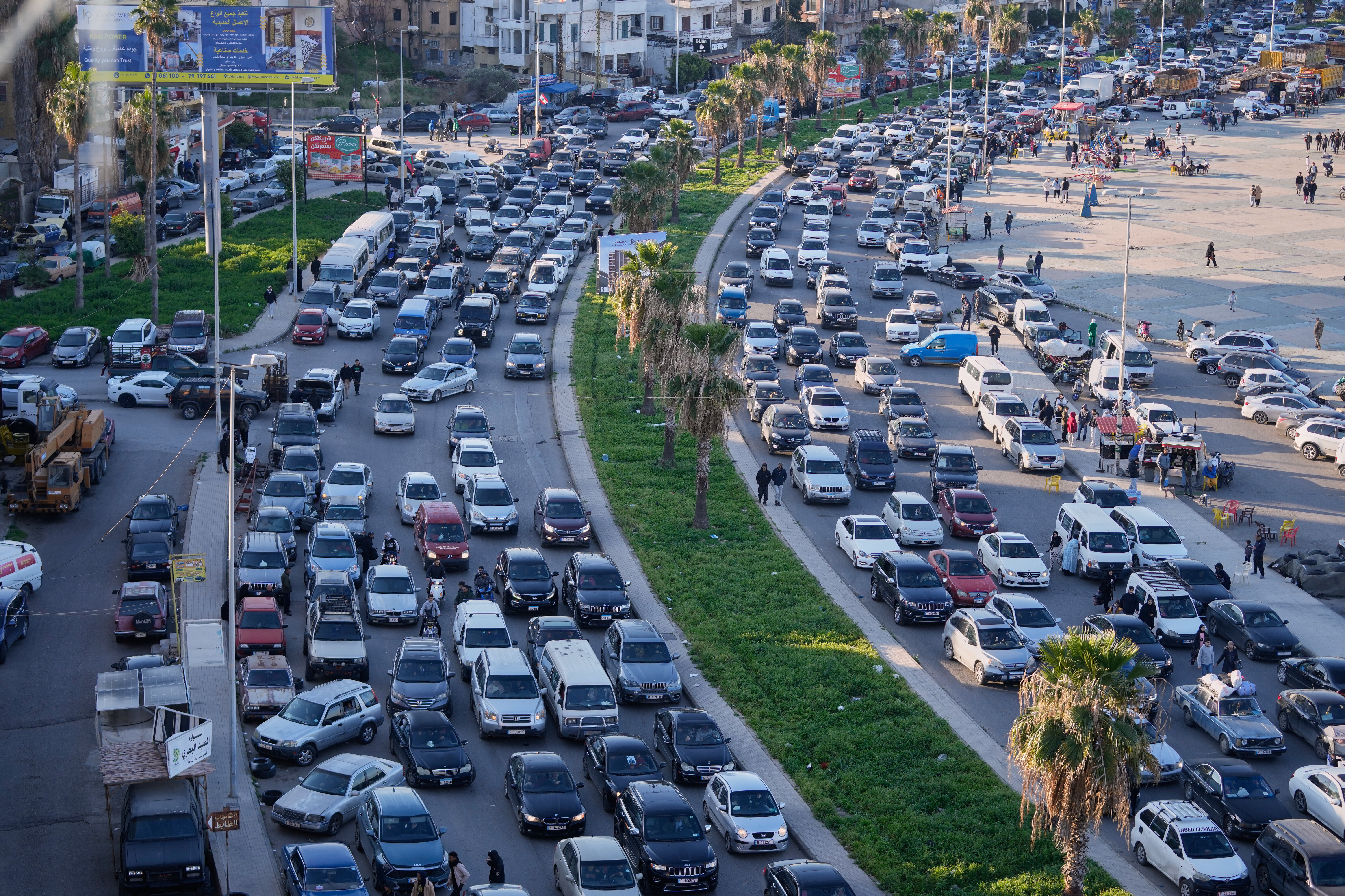 Displaced people fleeing Israeli strikes in southern Lebanon sit in traffic at a highway links to Beirut, in the southern port city of Sidon, Monday, March 2, 2026.