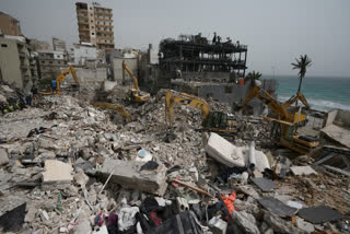 Excavators remove rubble from destroyed buildings that were hit by Israeli airstrikes on Thursday, as rescuers search for victims in the city of Tyre, southern Lebanon, Saturday, April 18, 2026.