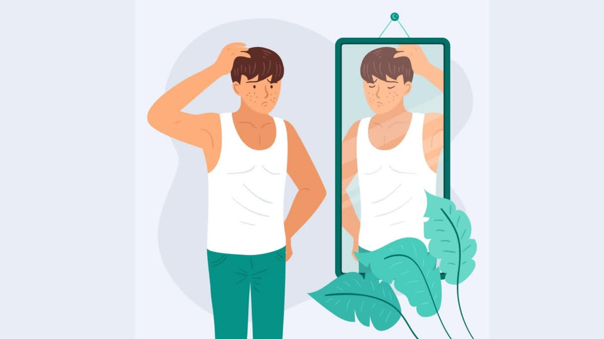 Slim man looking at himself in the mirror