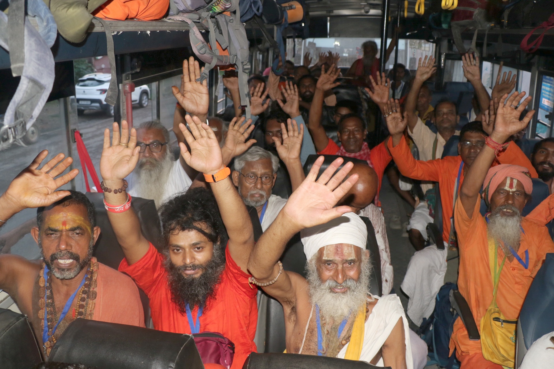 Sadhus seated in a bus as the first batch of pilgrims leave for Amarnath Yatra from Bhagwati Nagar Yatri Niwas base camp, in Jammu on Thursday.