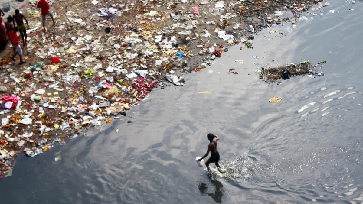 Waste pickers collect garbage along the banks of the Yamuna River in New Delhi on Monday, February 17, 2025.