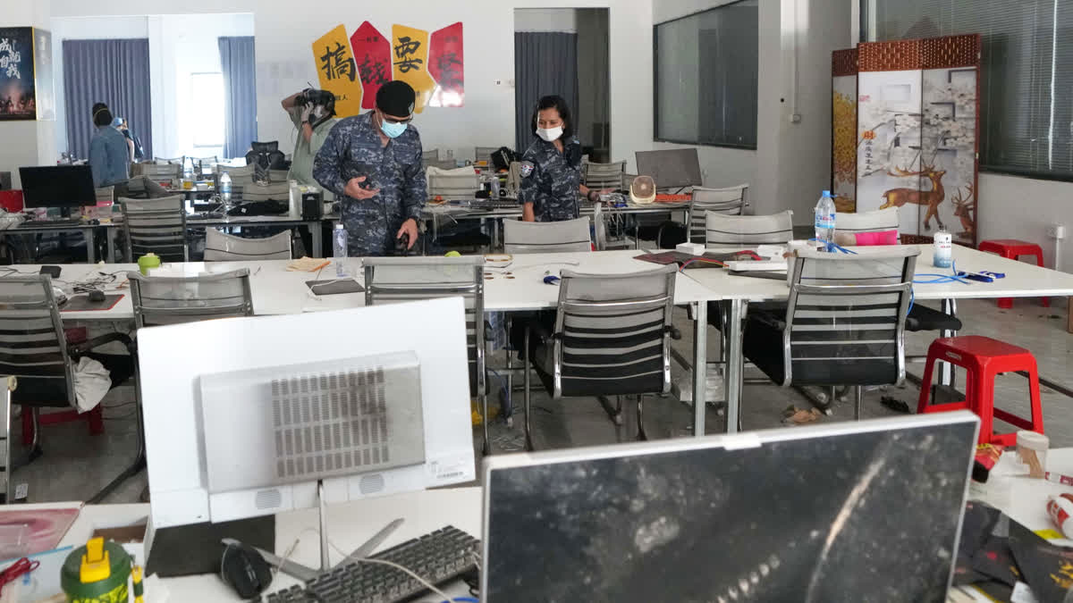 FILE - Thai soldiers inspect a work station at the scam compound in O'Smach, Cambodia, April 7, 2026.