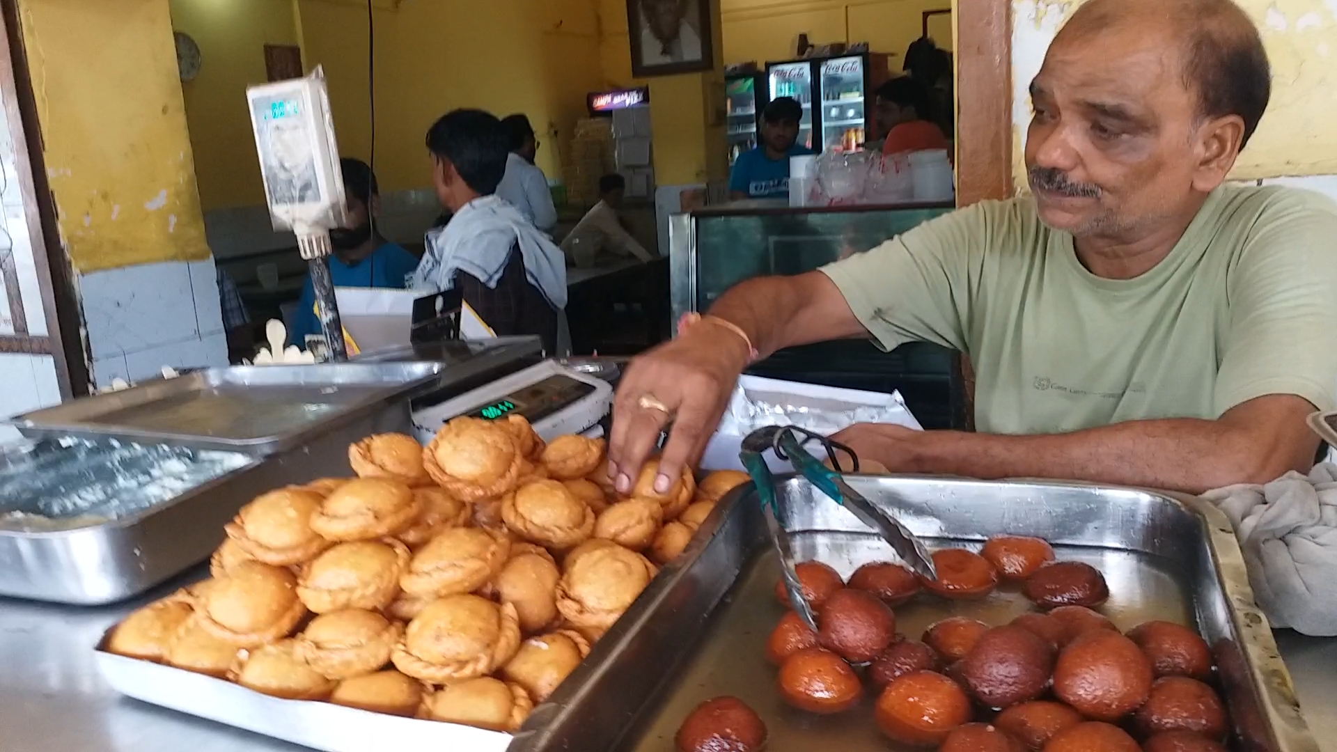 A shopkeeper sells 'Chandrakala' sweet in Barabanki, Uttar Pradesh