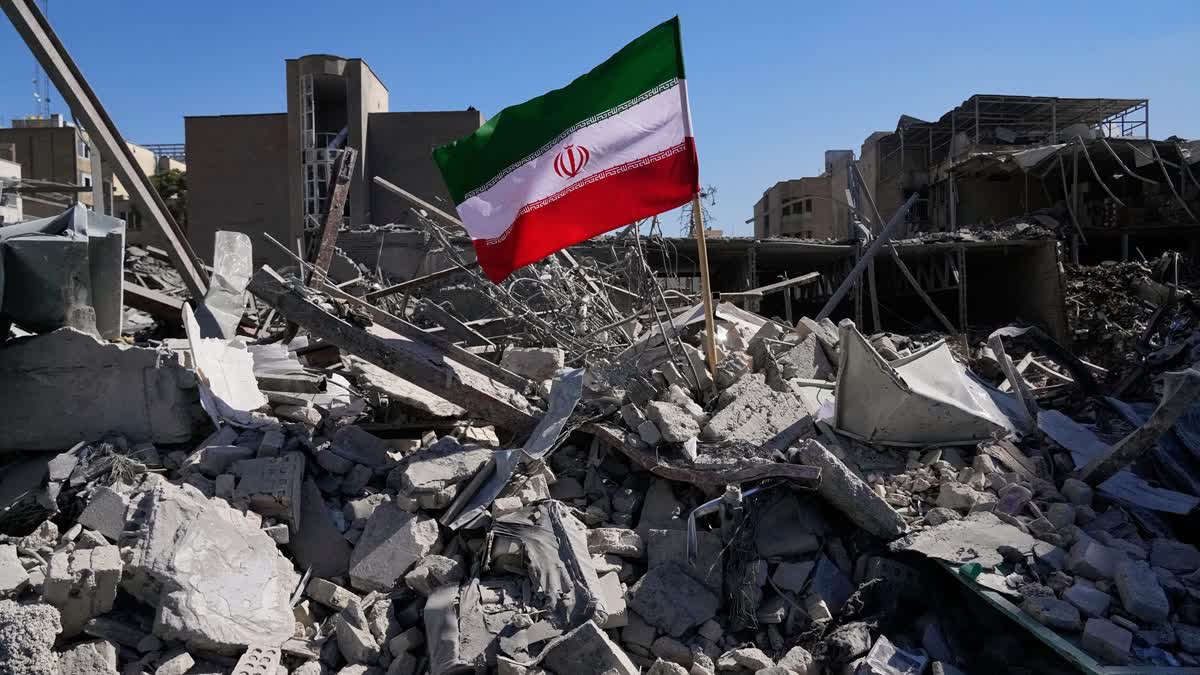 An Iranian flag is placed among the ruins of a police station struck Monday during the U.S.–Israeli military campaign in Tehran, Iran, Tuesday, March 3, 2026.