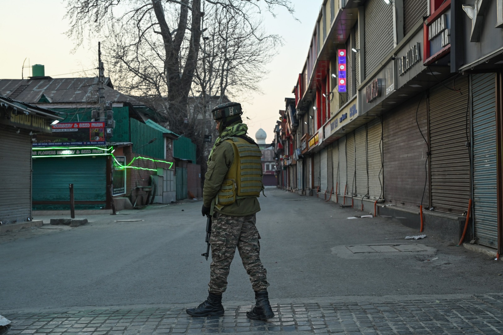A paramilitary force personnel patrols an area in Srinagar amid curbs to foil Shia protests against Ayatollah Khamenei assassination