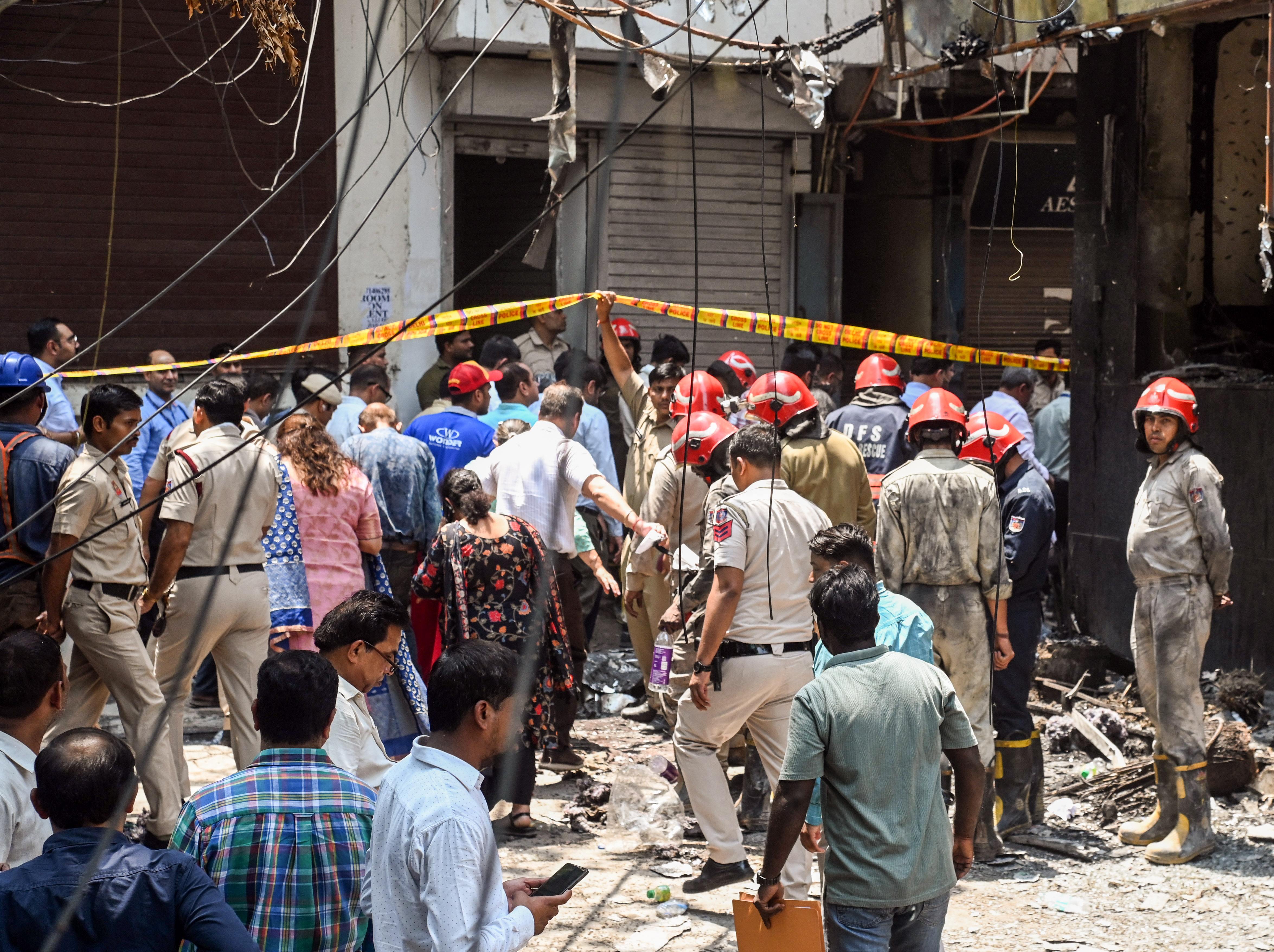 Police personnel at the site where a fire broke out in a restaurant at Malviya Nagar.