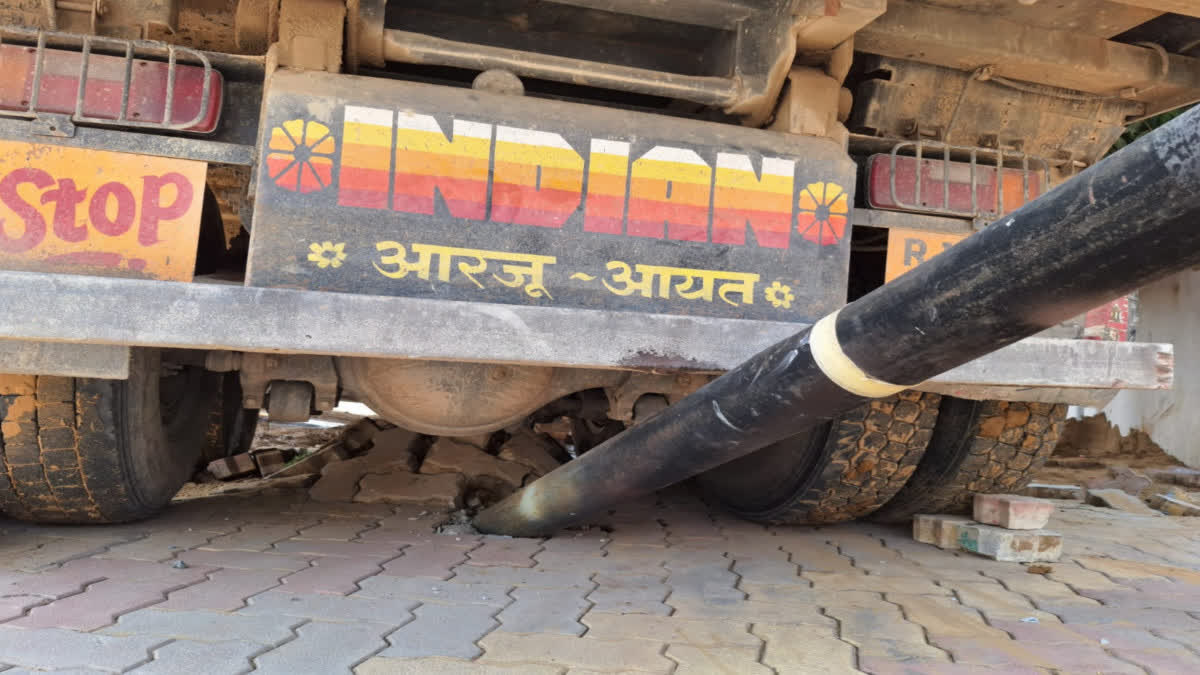 Truck stopped after hitting a pole.