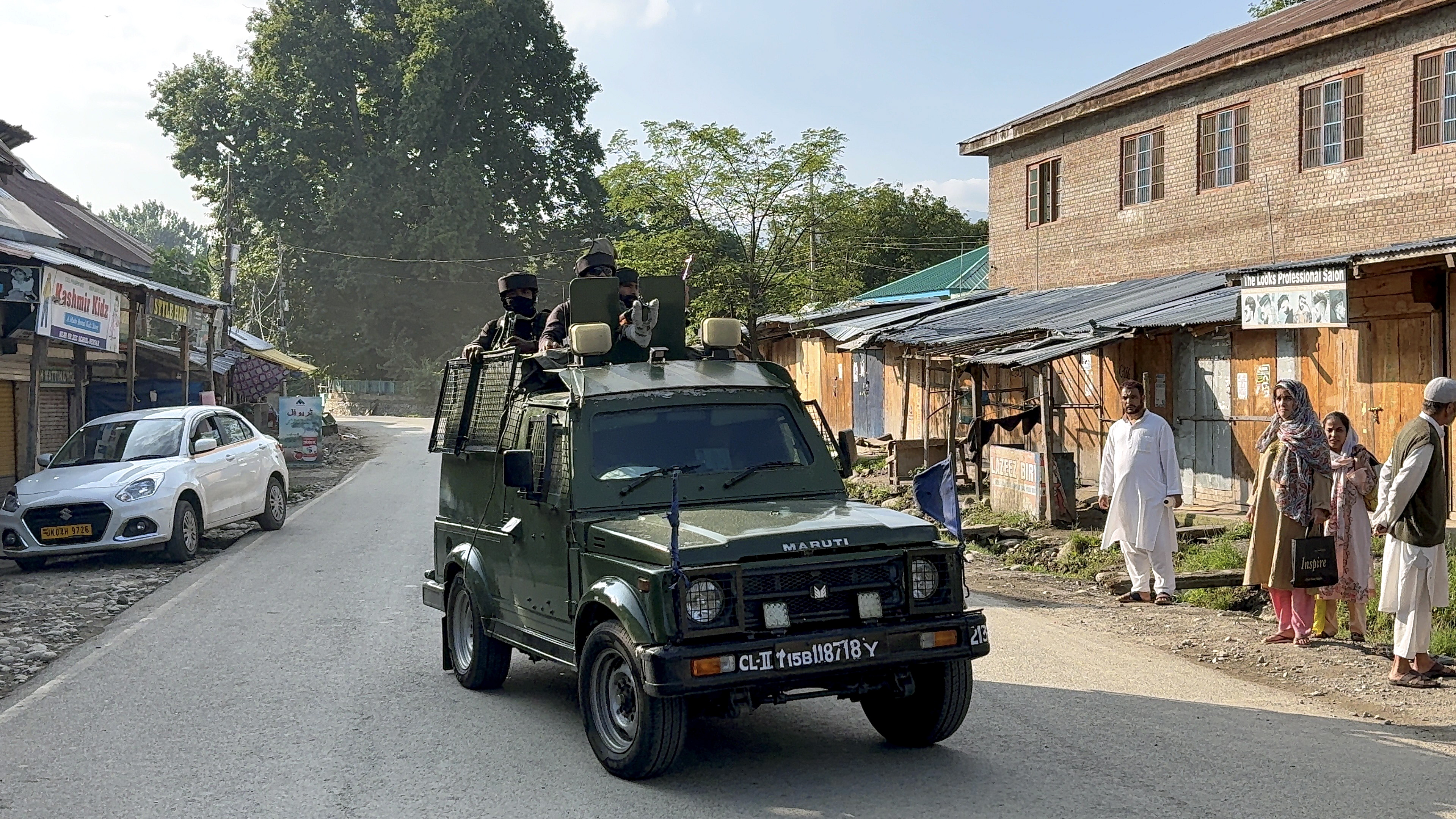 Security personnel keep a vigil amid an ongoing encounter between security forces and terrorists in a forest area at Akhal, in Kulgam district, Jammu and Kashmir, Sunday, Aug. 3, 2025.