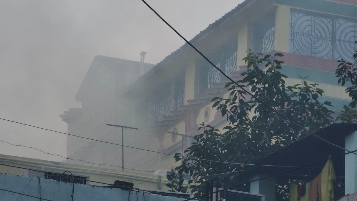 Smoke billows out from Bayron Biswas's house in Dhuliyan.