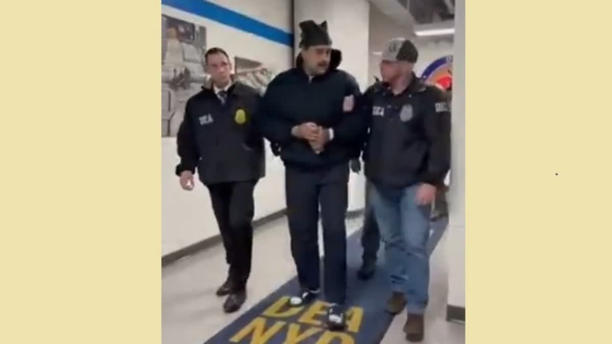 Venezuelan President Nicolas Maduro (C) escorted by DEA agents inside the headquarters of the US Drug Enforcement Administration (DEA) in lower Manhattan, New York