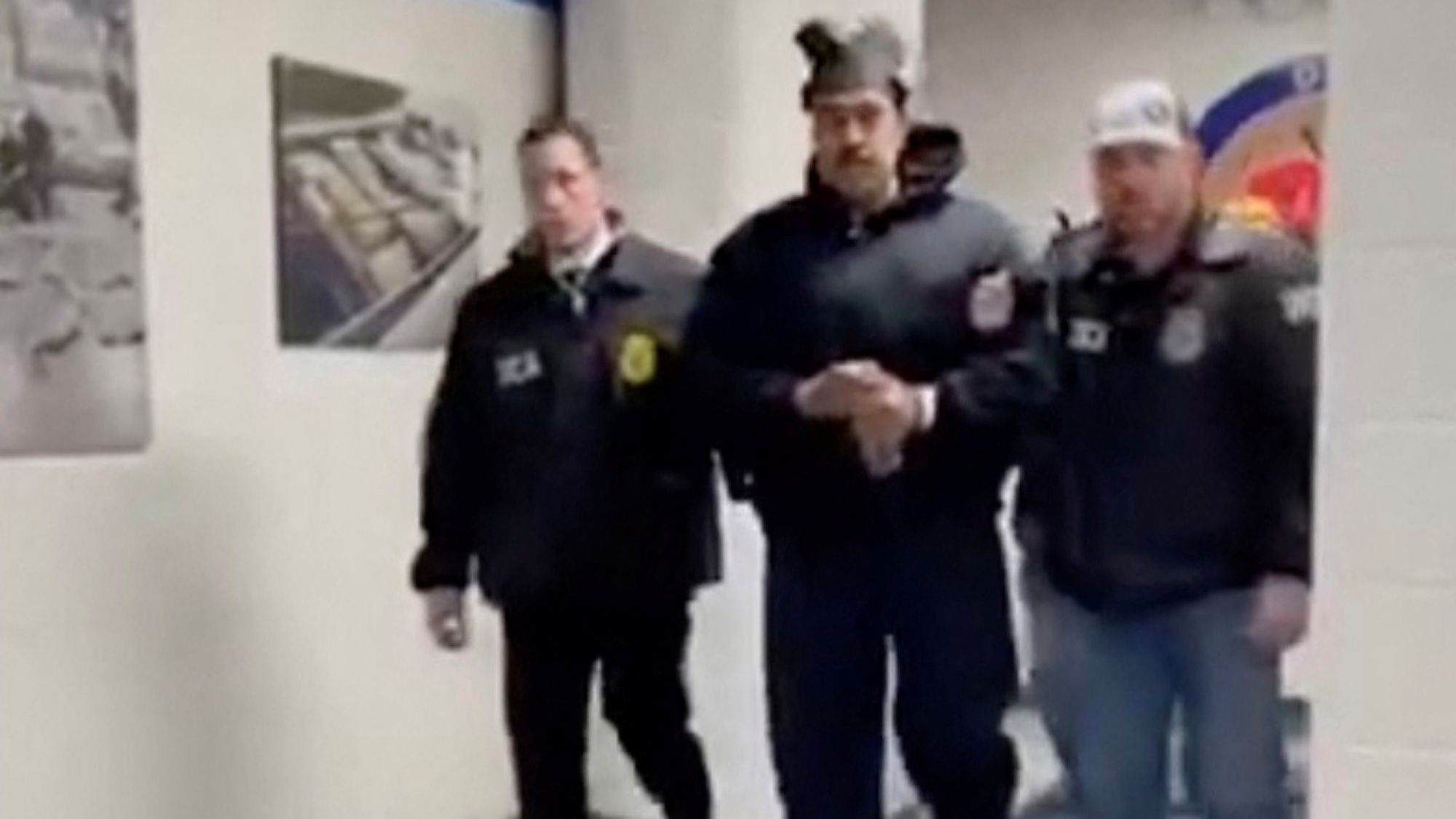 This screengrab taken from the X account of Rapid Response 47, the official White House rapid response account, shows Venezuelan President Nicolas Maduro (C) escorted by DEA agents inside the headquarters of the US Drug Enforcement Administration (DEA) in lower Manhattan, New York, on January 3, 2026.