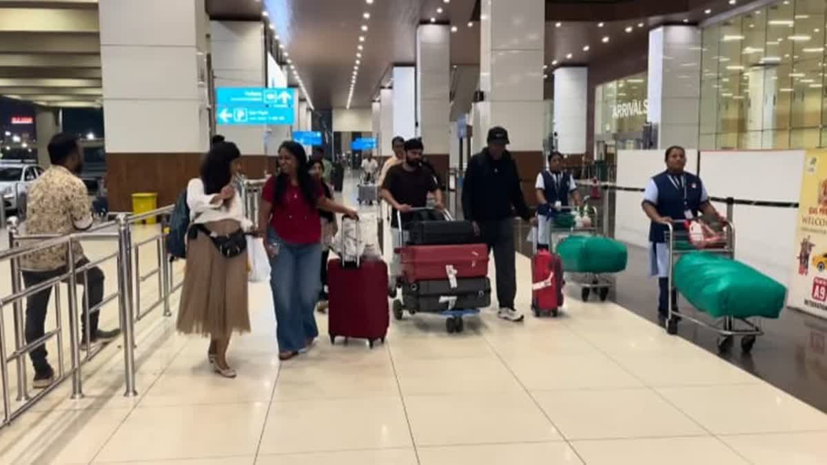 Indian expatriates land at the Cochin airport after being evacuated from the UAE