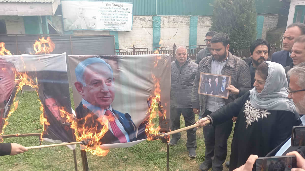 PDP President Mehbooba Mufti(R) sets ablaze pictures of US President Donald Trump and Israel PM Benjamin Netanyahu at party headquarters in Srinagar