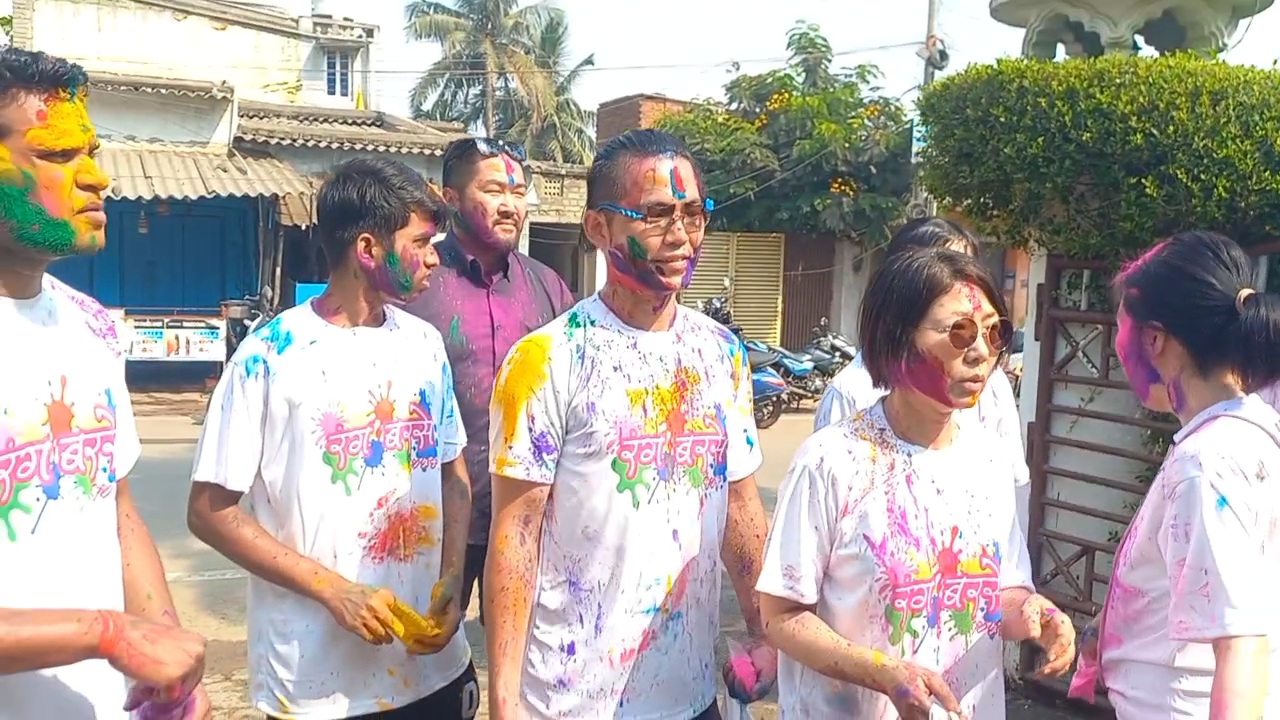 Japanese tourists  celebrate Holi in Puri