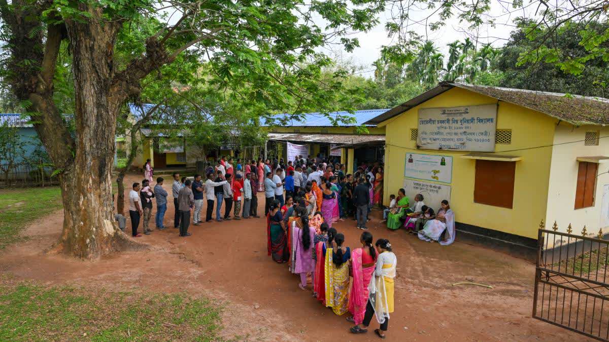 A file photo of voters in a queue at a polling station in Kamrup.