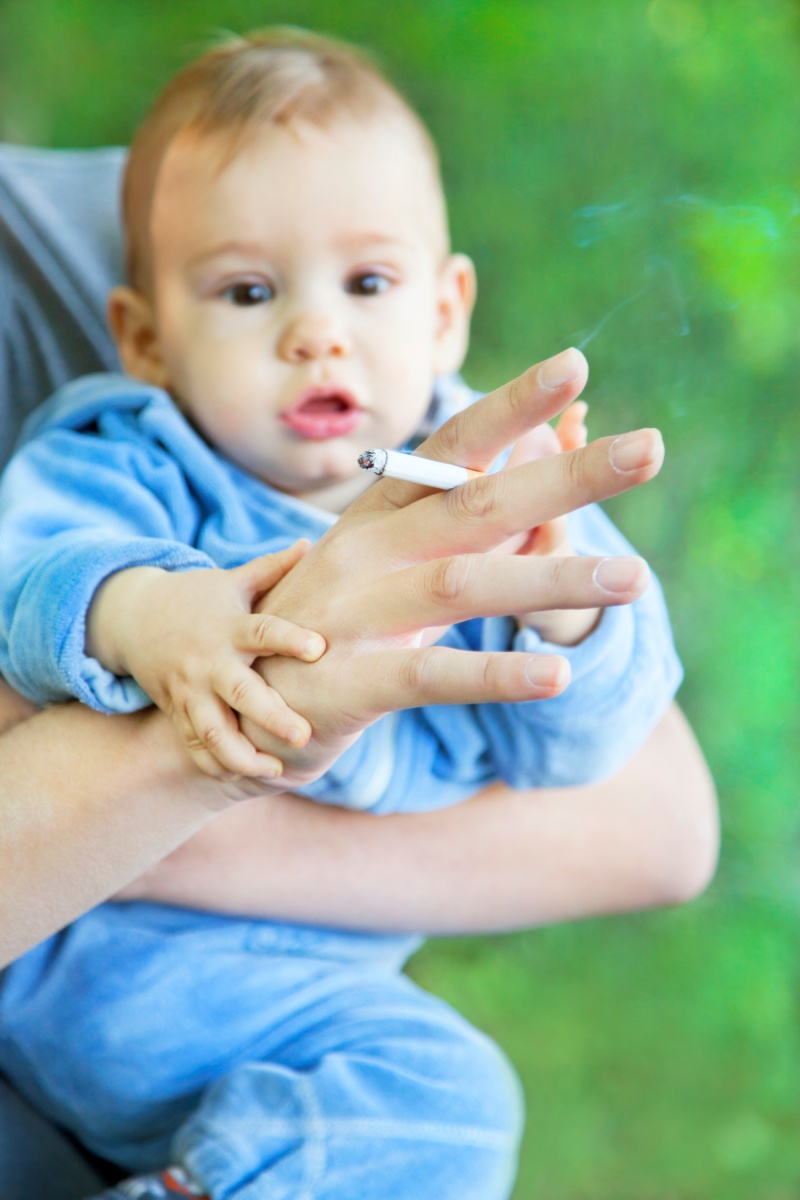 Baby and smoking father