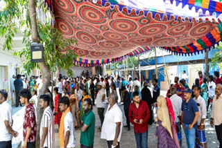 FILE- Voters queue up as they wait to cast their votes during the first phase of the Tamil Nadu Assembly election, in Chennai.