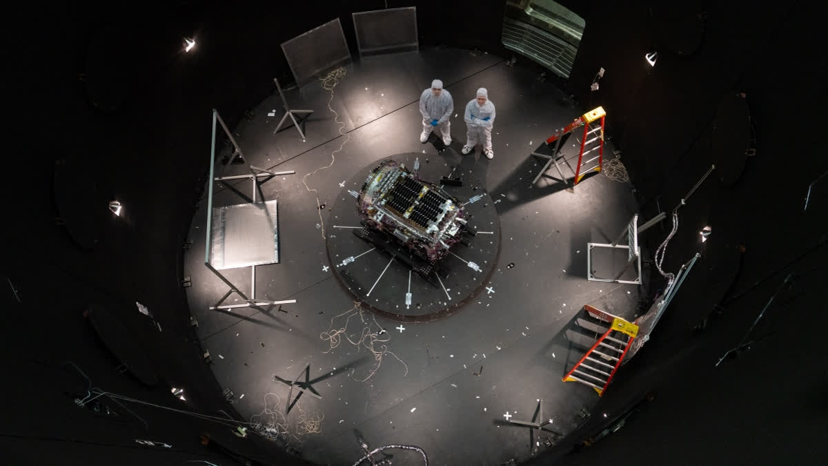 This photo provided by NASA shows Kieran Wilson, LINK’s principal investigator, and Hunter Robertson, a space systems engineer, both at Katalyst Space, standing next to their spacecraft inside the SES (Space Environment Simulator) at NASA’s Goddard Space Flight Center in Greenbelt, Md., April 17, 2026, ahead of thermal vacuum testing