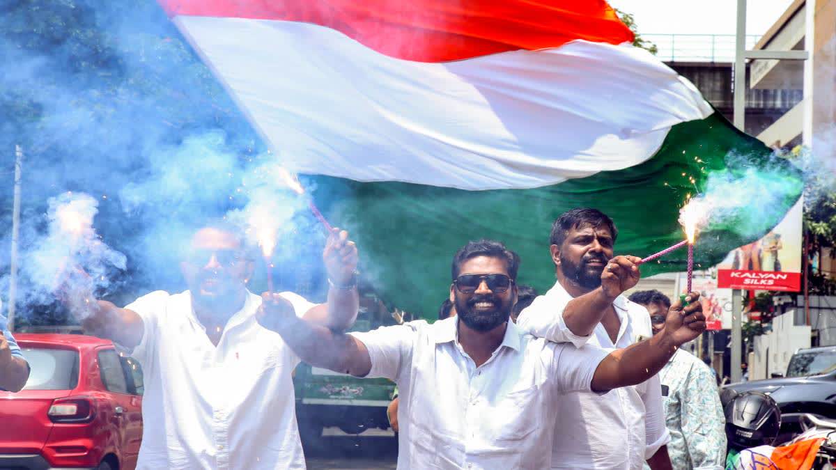 Congress workers celebrate party's landslide victory in the Kerala assembly elections.