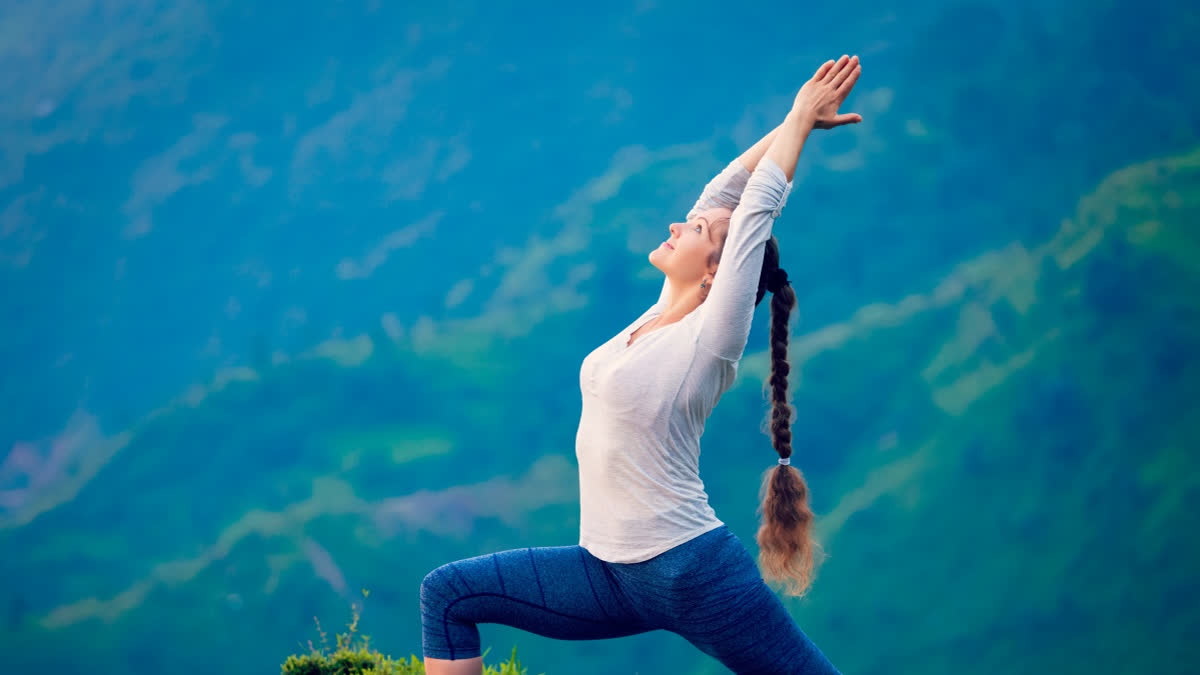 Can Yoga Keep Diabetes In Check? Here's What New Research Says Woman doing yoga on a mountain