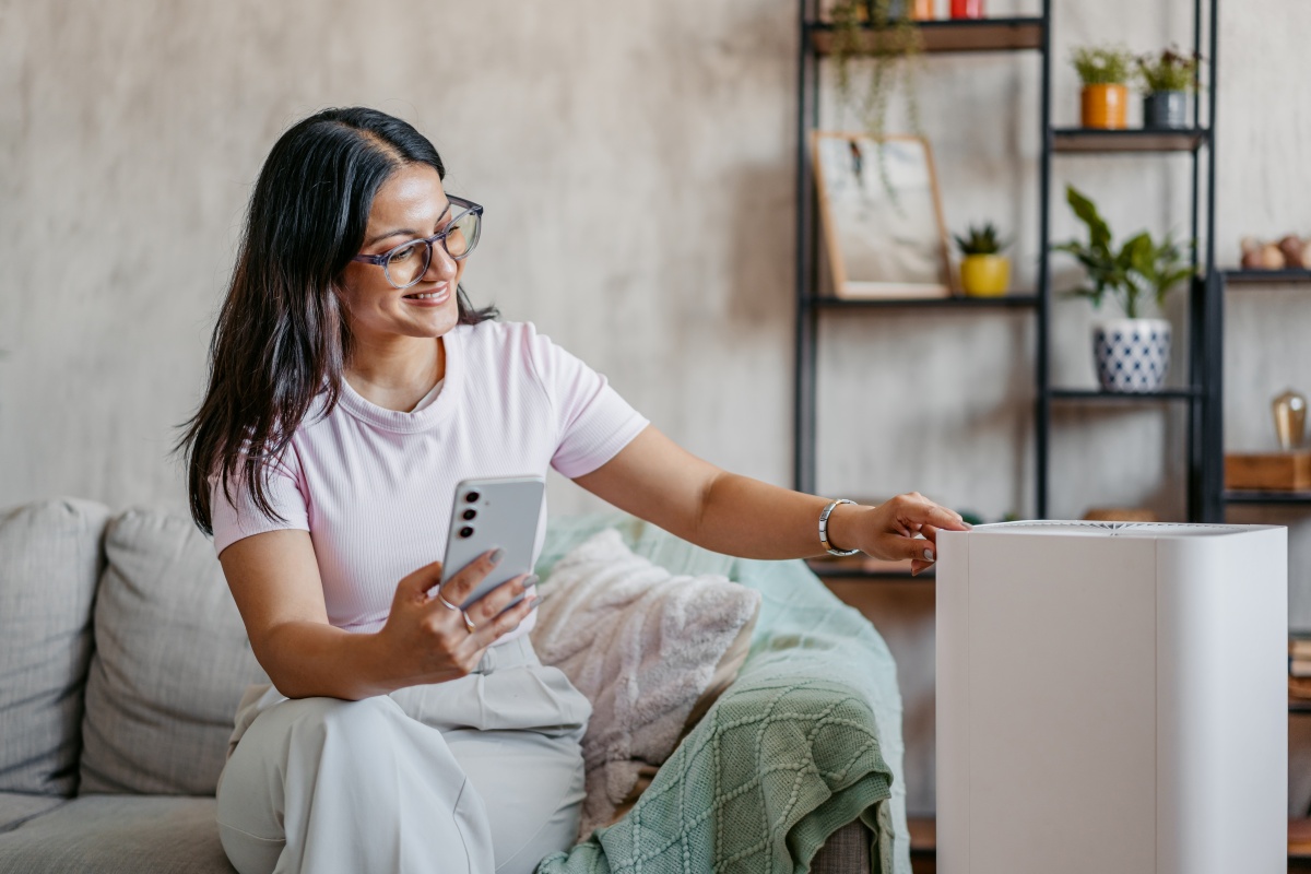Woman looking at her air purifier