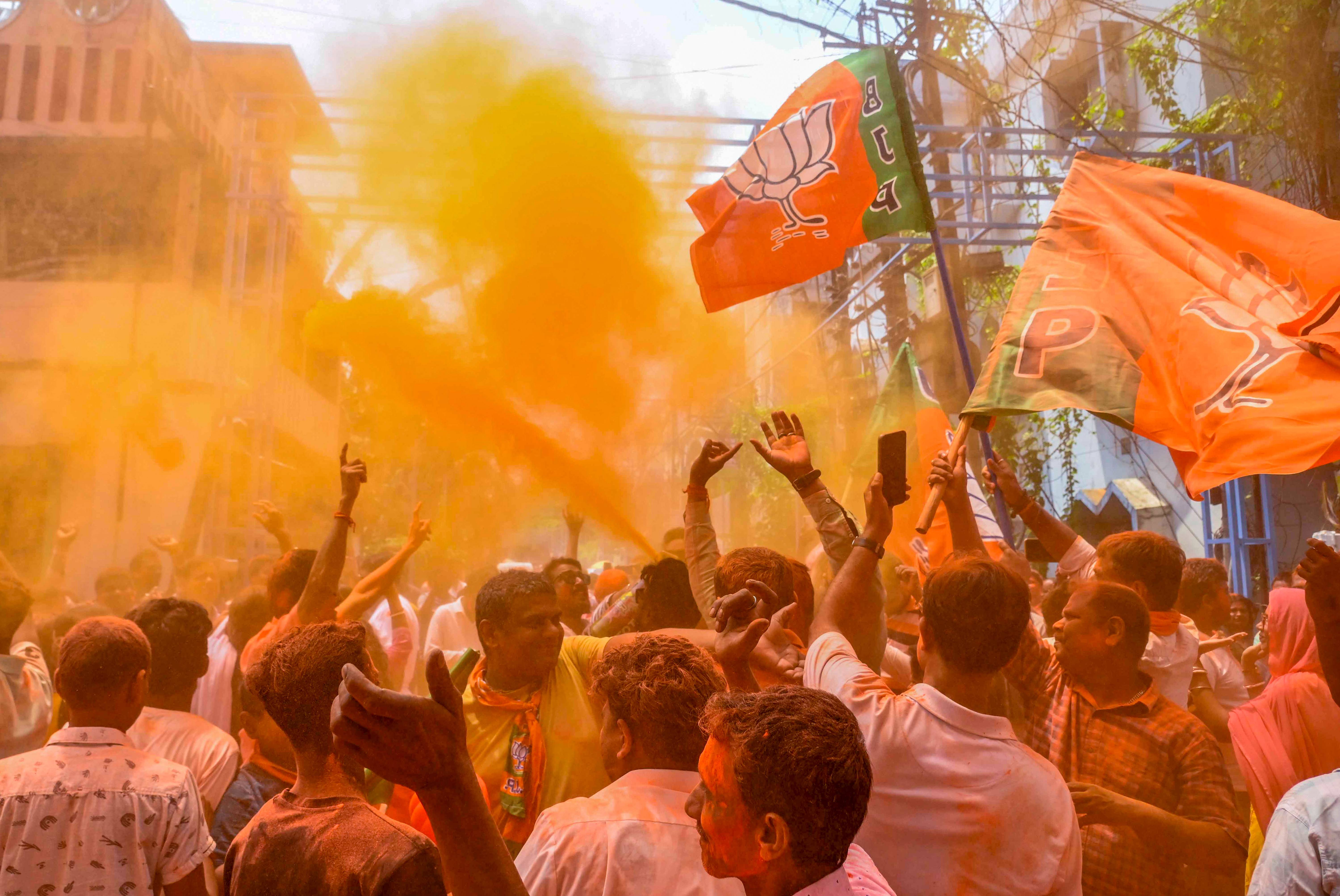 BJP supporters celebrate with coloured powder after party's winning in Dakshin Dinajpur.