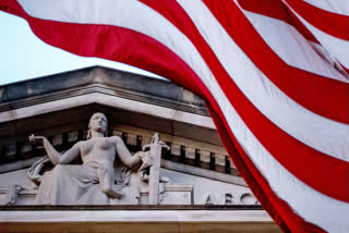 FILE - An American flag flies outside the Department of Justice in Washington, March 22, 2019.