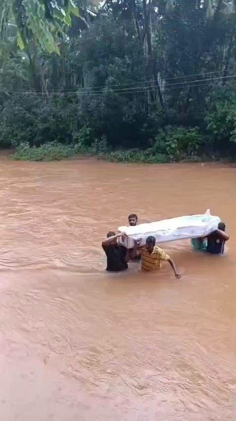 Villagers Carrying Dead Body in Water