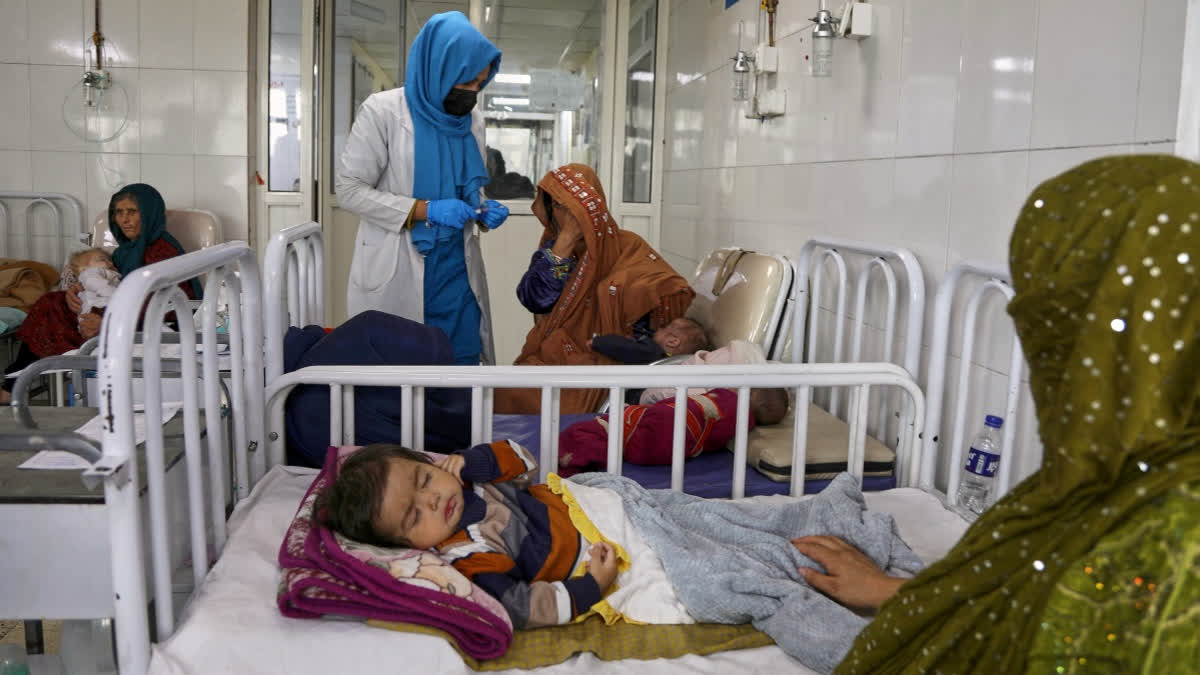 FILE - Afghan women care for their children in the malnutrition ward at Indira Gandhi Children's Hospital in Kabul, Afghanistan, Feb. 15, 2026.