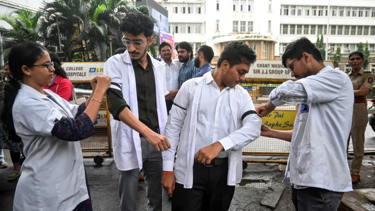 Medical students tie black bands on each other's arms as the IMA holds a day strike following the Maharashtra Medical Council’s (MMC) announcement to launch a portal for the registration of the Certificate Course in Modern Pharmacology (CCMP)-qualified doctors at J J Hospital, in Mumbai.