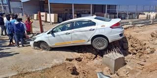 A CAR CRASHED INTO A BESIDE CAR AND JUMPED OVER THE DIVIDER WITH IT.